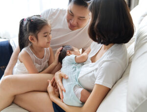 Breast feeding newborn baby at home.